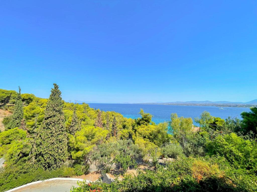 a road on a hill with the ocean in the background at Casa Bianca Elegant House Near Beach in Spetses