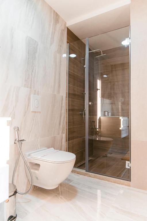 a bathroom with a toilet and a glass shower at CAROLEA VILLAS in Ulcinj