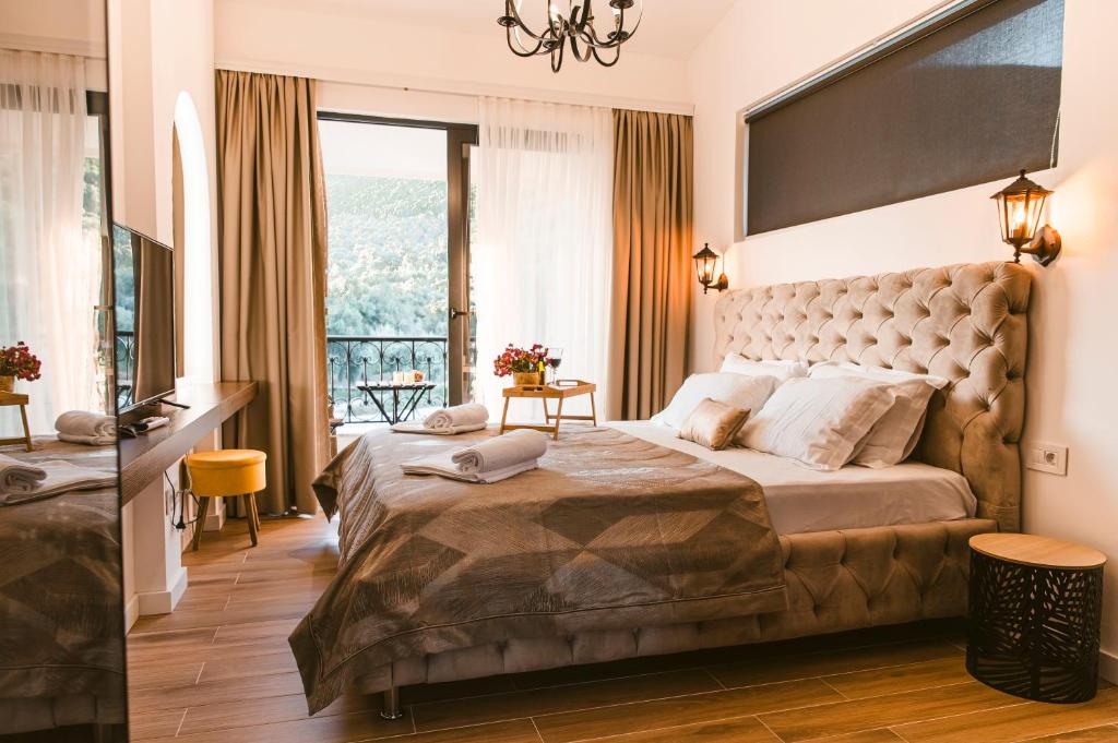 a bedroom with a large bed with a large window at CAROLEA VILLAS in Ulcinj