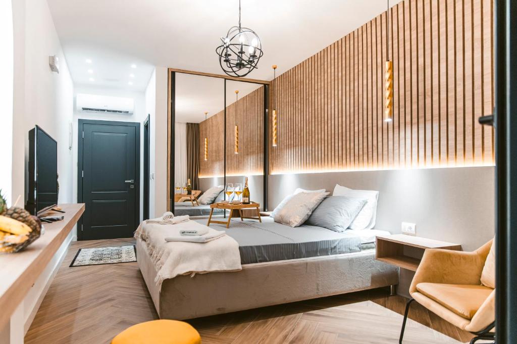 a bedroom with a large bed and a chair at CAROLEA VILLAS in Ulcinj