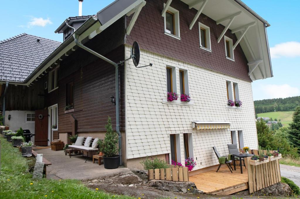 a house with a deck and a patio at Haus Bergruh Fuchsbau in Todtnauberg