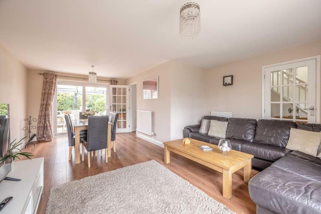 a living room with a couch and a table at 3-Bed Family Home with Parking & Large Garden in Windsor