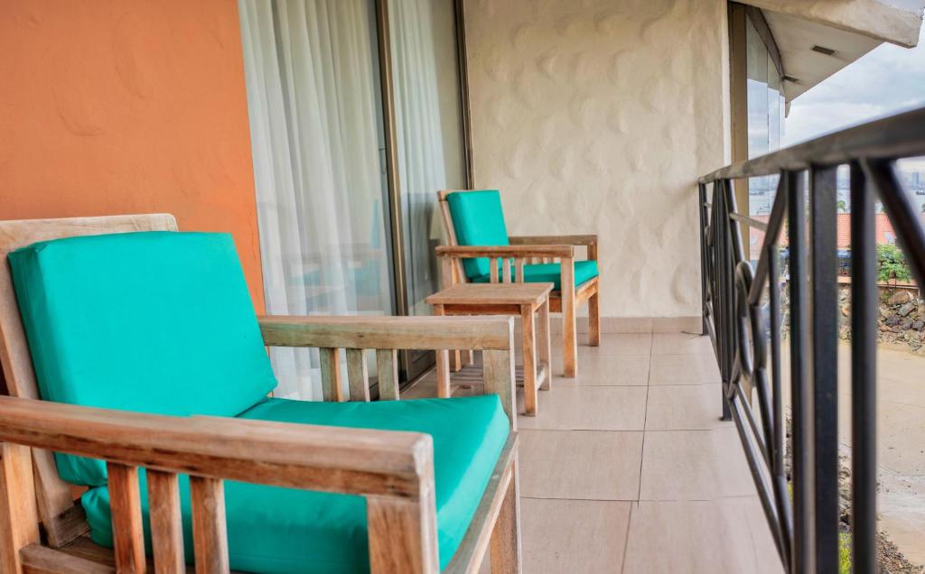 a row of chairs and tables on a balcony at The Beach House in Panama City