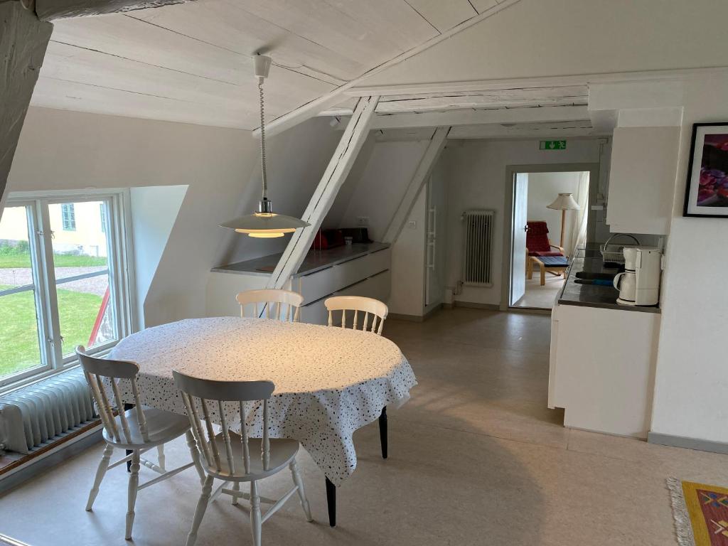 eine Küche und ein Esszimmer mit einem Tisch und Stühlen in der Unterkunft Gåvetorps Gård in Alvesta