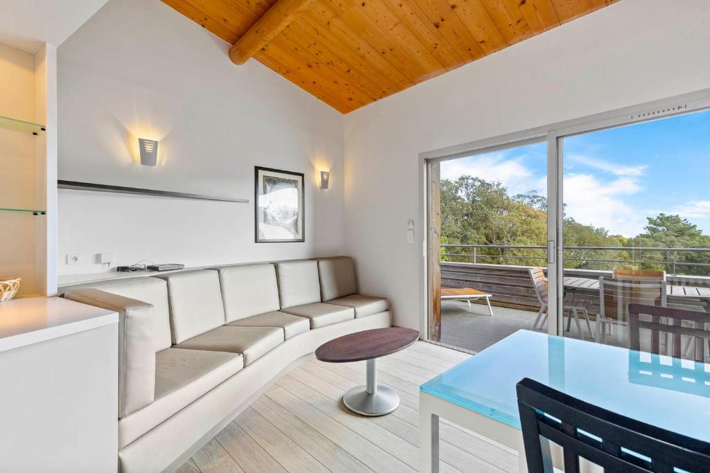 a living room with a couch and a table at Résidence Cala Sultana Appartement T2 in Porto-Vecchio