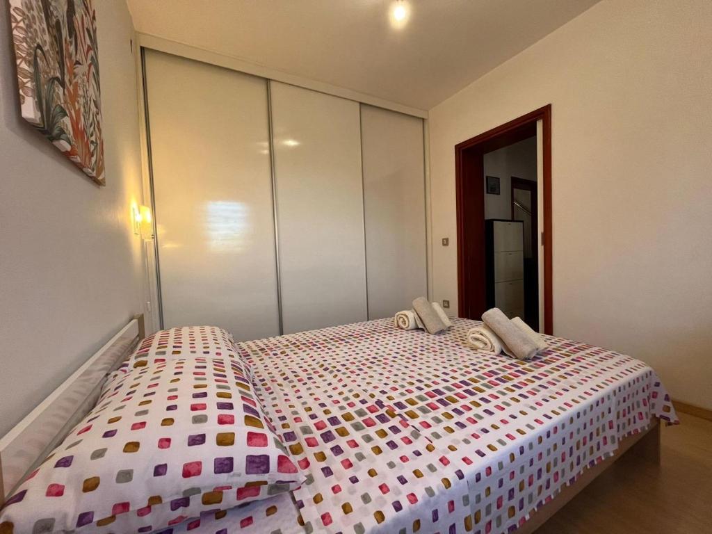 a bedroom with a bed with a polka dot blanket at Apartment Leda in Kraljevica