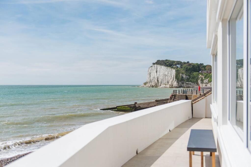 a balcony with a view of the ocean at Sea Purse - Spectacular house on the beach in Kent