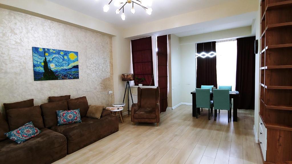 a living room with a couch and a dining room at Dona Tbilisi in Tbilisi City