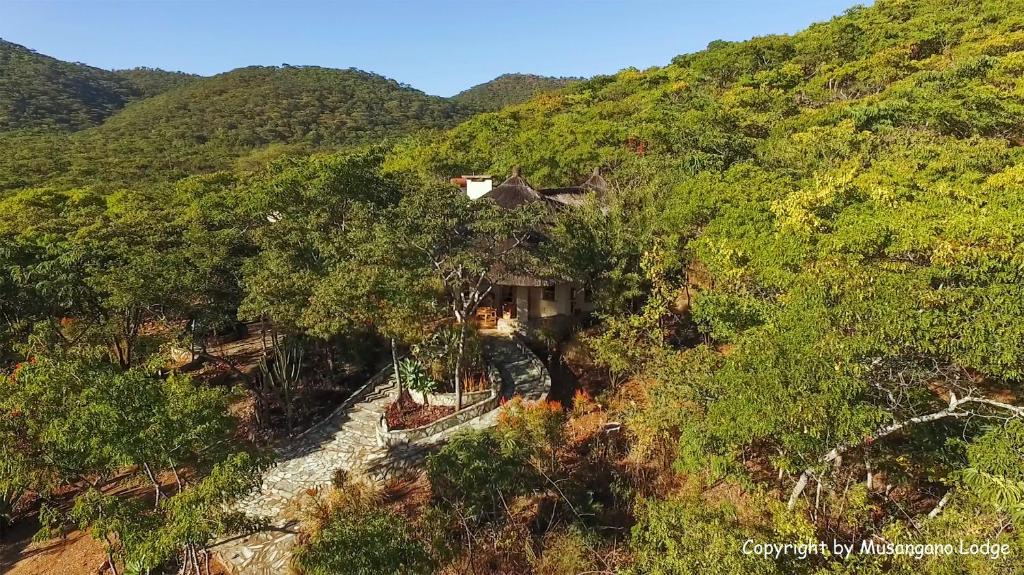 an aerial view of a house in the middle of a hill at Musangano Lodge in Odzi