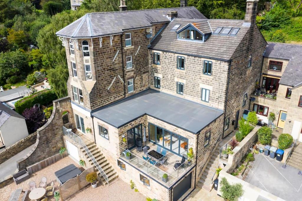 an aerial view of a large brick house with a roof at Swallow View, A Spacious Base with stunning views in Matlock