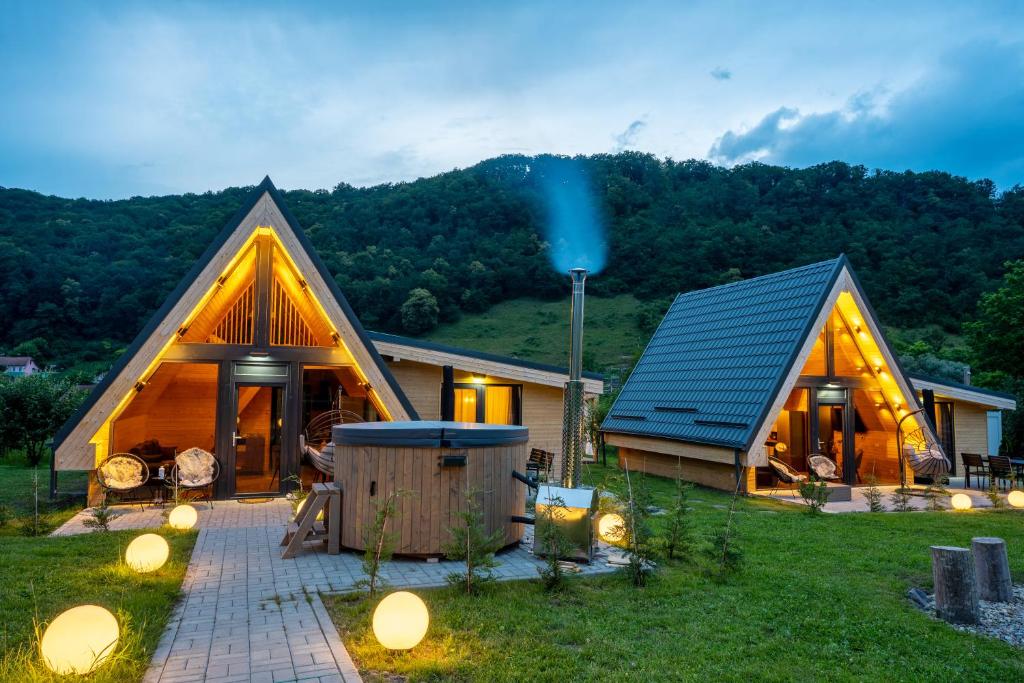 a home with a house with a green mountain at Ungefug A-Frame Sighisoara in Sighişoara