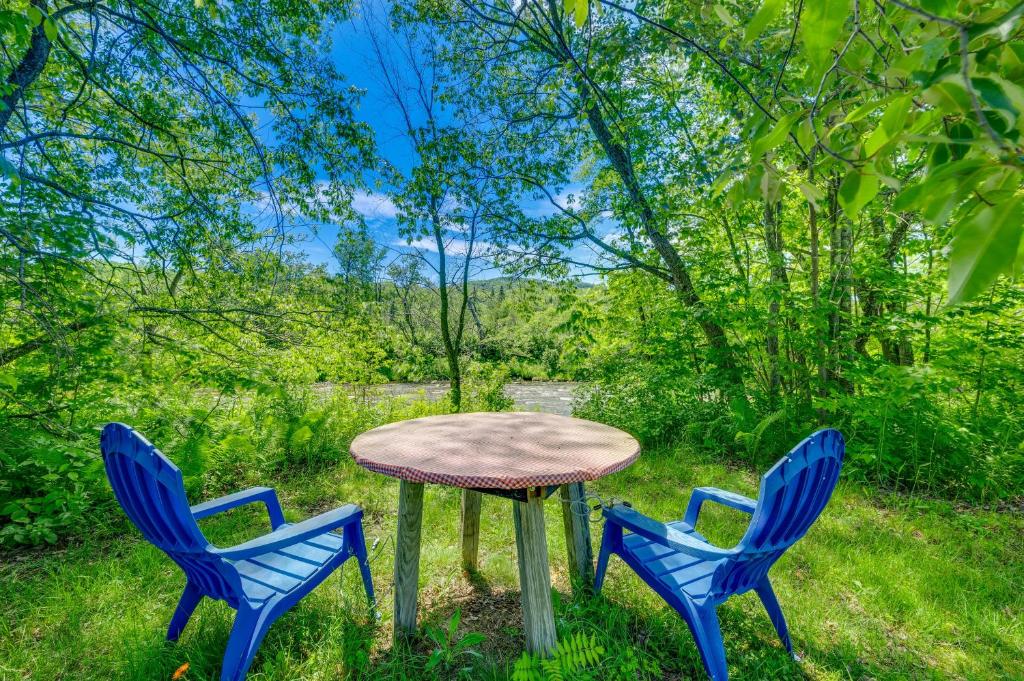three chairs around a table in the grass at Franconia Home with Piano, Fire Pit and Community Pool in Franconia