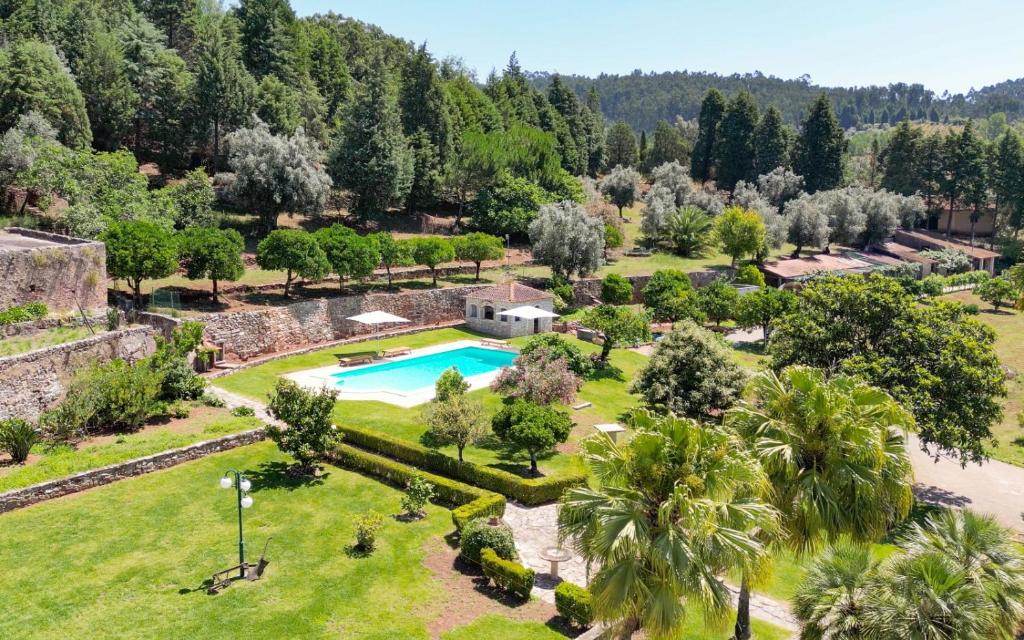 an aerial view of a resort with a swimming pool and trees at Quinta do Calvário 