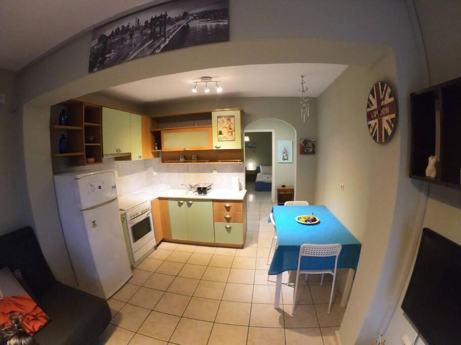 a kitchen with a blue table in a room at Mavretas Apartments 4 in Argassi