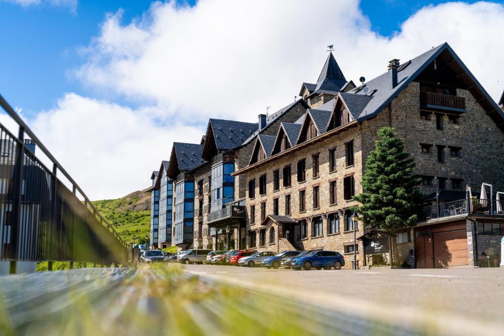 a large building on a street with cars parked in front at Snö Villa de Sallent 3 in Formigal