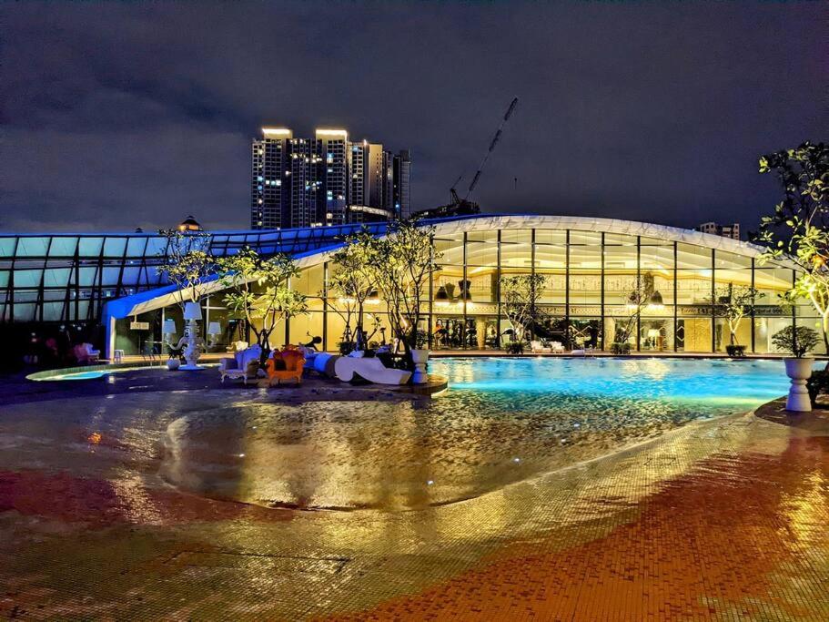 a large building at night with a building at Arte Mont Kiara Studio Apartment Hartamas in Kuala Lumpur