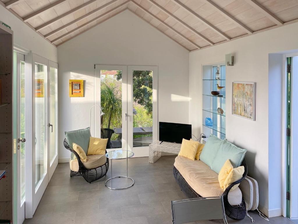 a living room with a couch and two chairs at Almendro in Puntagorda