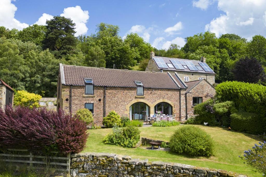 a house with solar panels on the roof at Five Acres in Thirsk