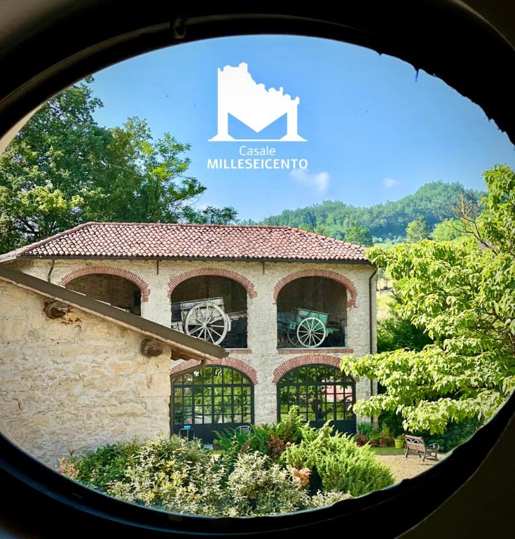 a view of a building with a round window at Casale Milleseicento in Gavi