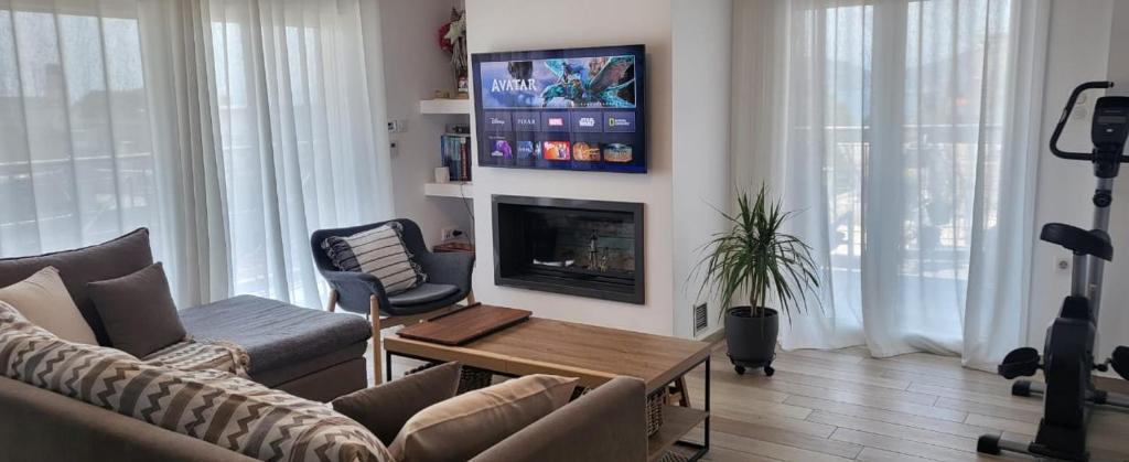 a living room with a couch and a fireplace at Central Park Apartment in Volos