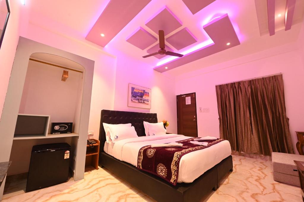 1 dormitorio con cama y techo con luces moradas en Hotel Quinta da Branca, en Baga