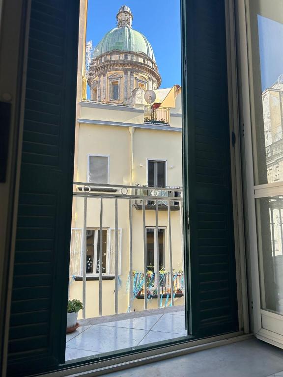 a view from a window of a building with a dome at O'Tuocc a Chiaia in Naples
