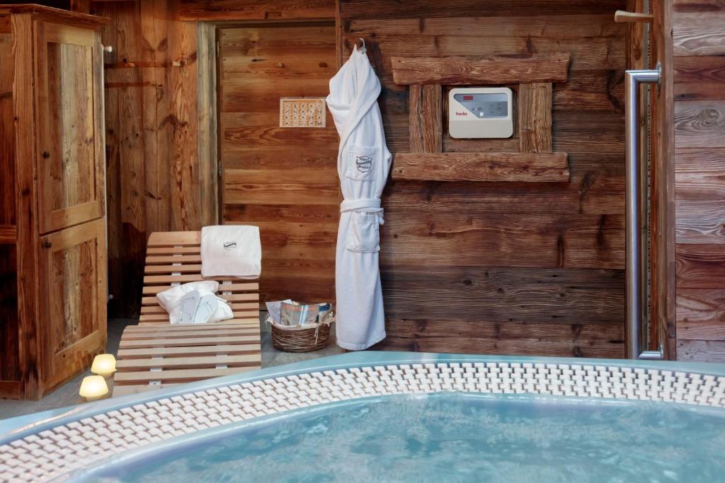 a jacuzzi tub in a room with a wooden wall at Chalet Matterhorn Francois with SPA and Breakfast - 100mt lift in Breuil-Cervinia