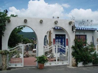 a building with a white fence and an archway at Fennel Resort in Checheng