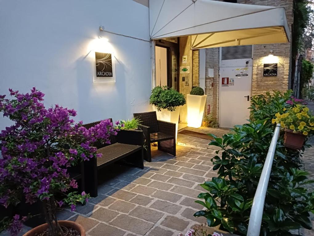 a patio with some purple flowers and plants at Hotel Arcadia in Macerata