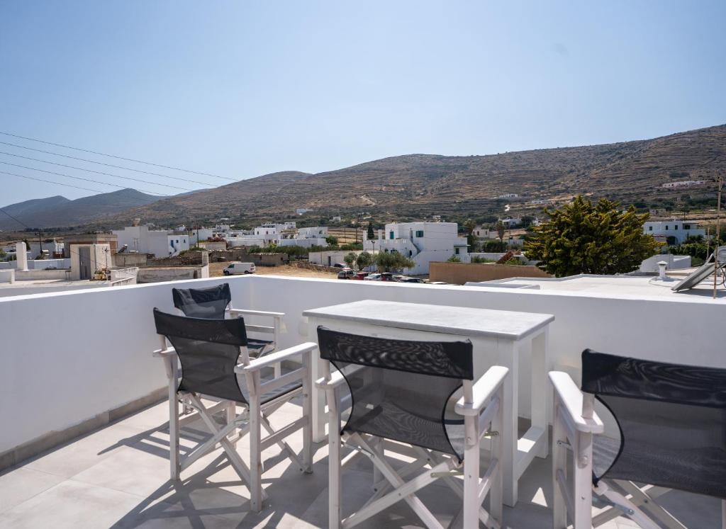 a table and chairs on a balcony with a view at Traditional White House 2 in Prodromos Paros