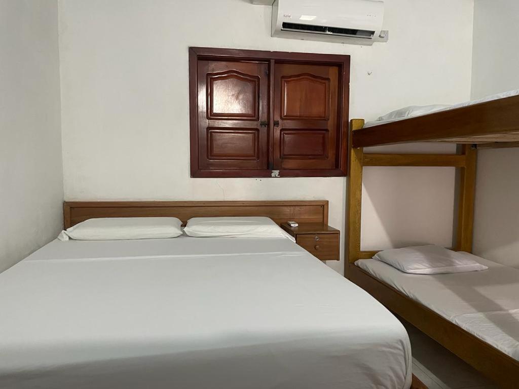 a bedroom with two beds and a bunk bed at kelly tours in Capurganá