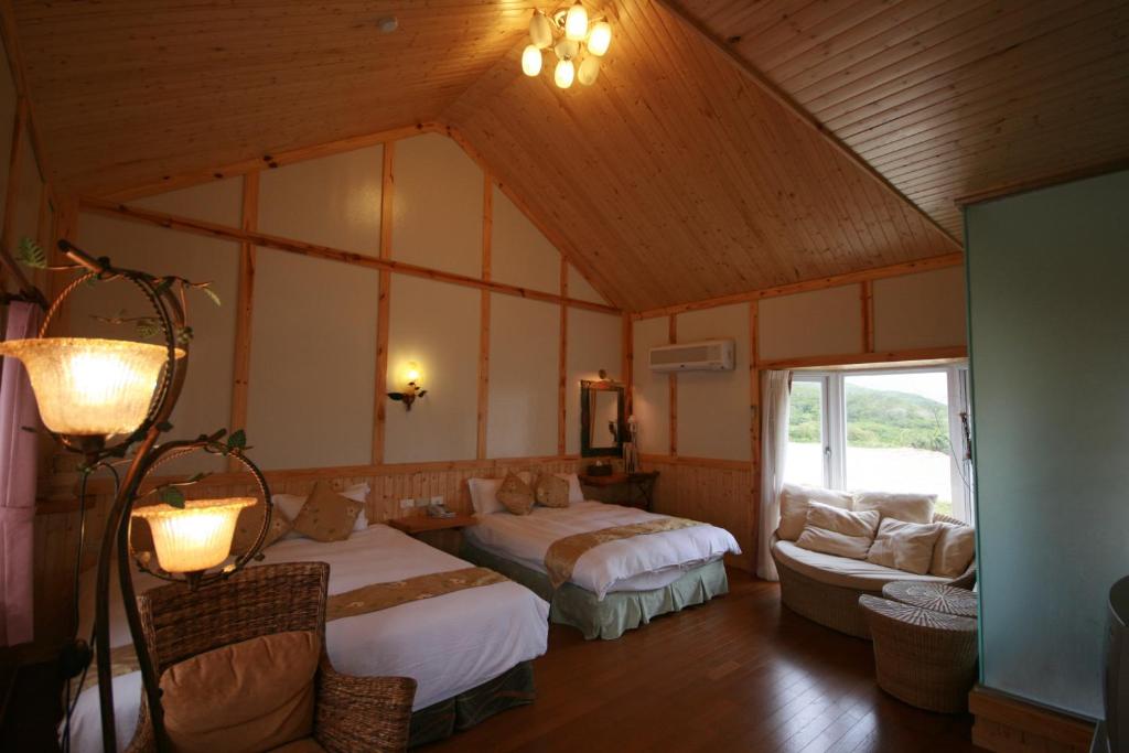 a large room with two beds and a couch at Fennel Resort in Checheng