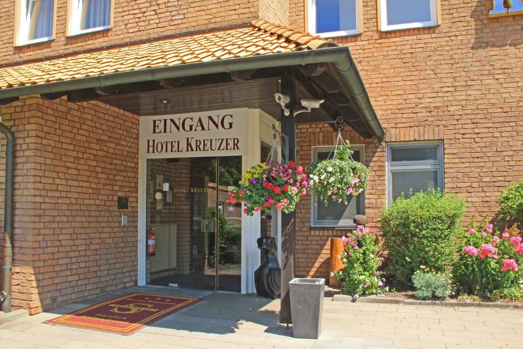 a brick building with a sign that reads emerging hotel kitchen at Hotel Kreuzer in Wedel