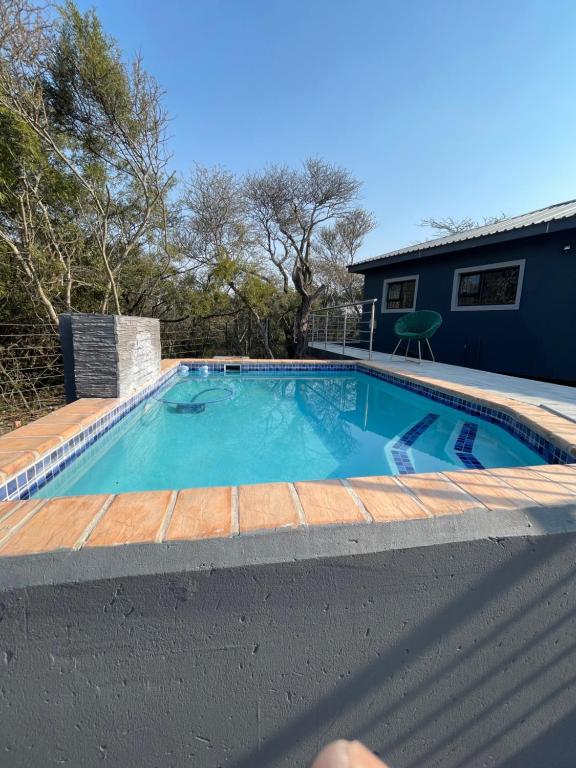 a swimming pool in a yard with a house at Kings view exclusive villas (KVEV) in Pretoria-Noord