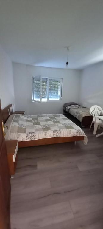 a bedroom with a large bed and a chair at Damjan's Apartments 