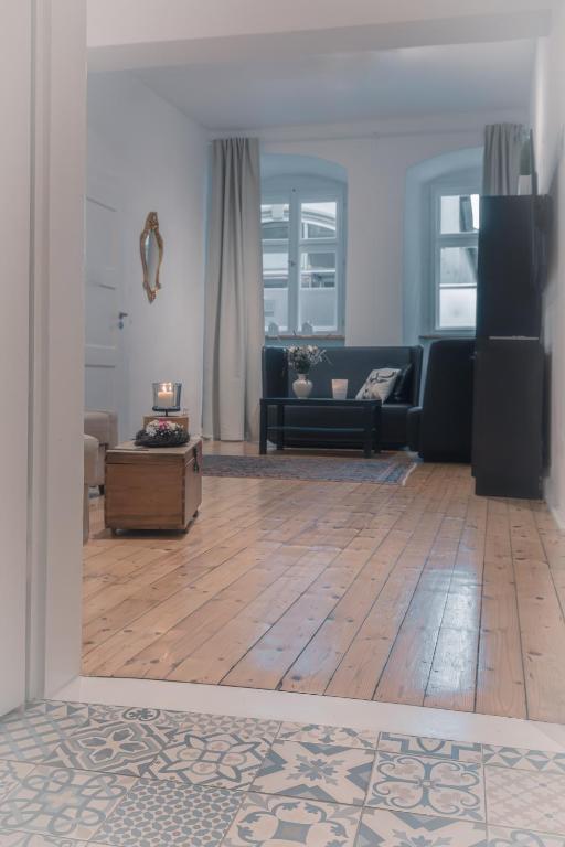 a living room with a couch and a wooden floor at Adam&Eva in Bamberg
