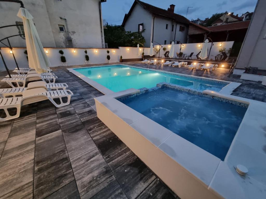 a swimming pool with lounge chairs and a swimming pool at Fenix Apartments in Soko Banja