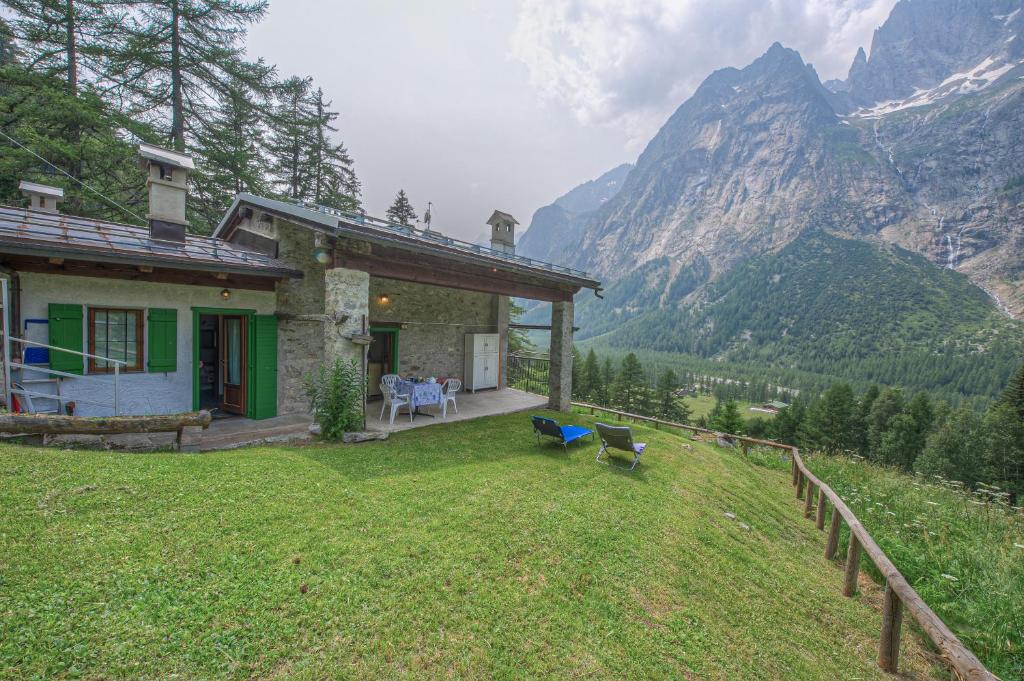 a house on a hill with a view of a mountain at Baita Margherita - Val Veny in Courmayeur