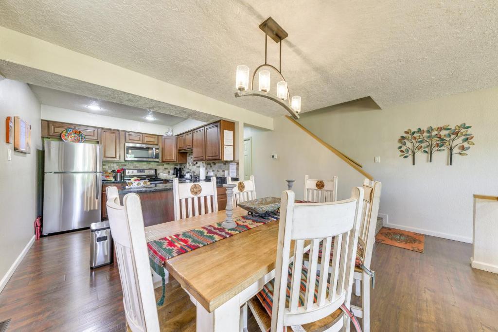 a kitchen and dining room with a table and chairs at Ruidoso Golf Condo - Patio, Fire Pit and Mtn View! in Ruidoso