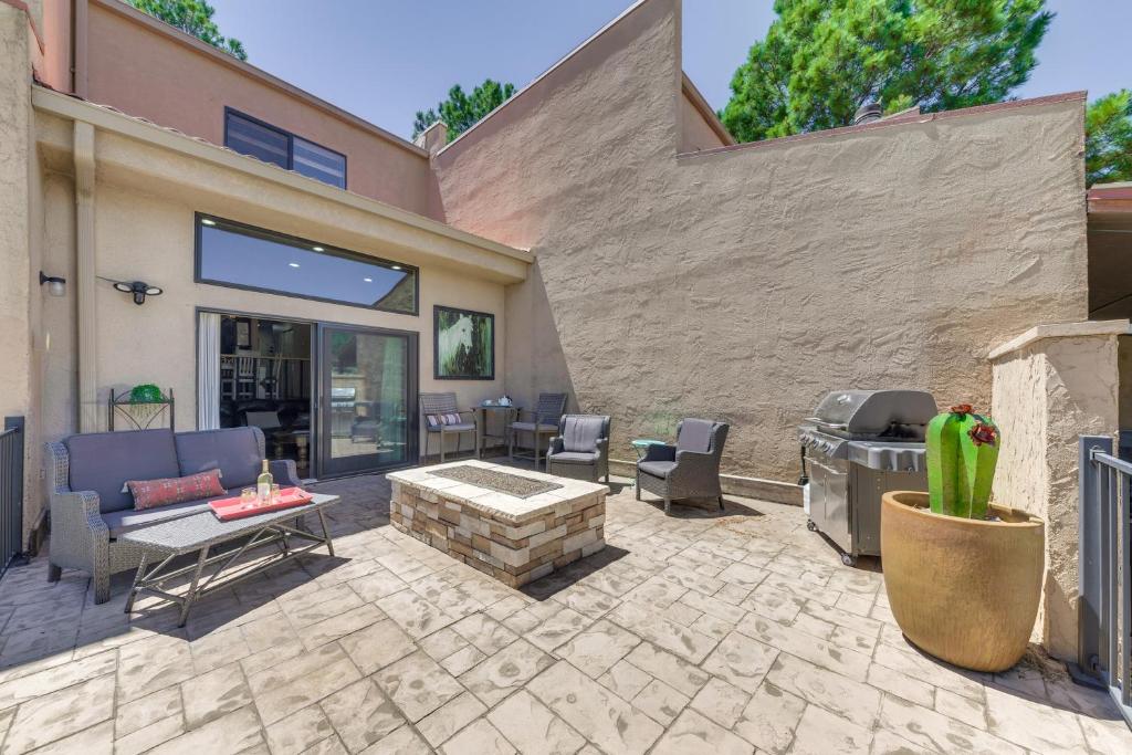 a patio with a fire pit and a grill at Ruidoso Golf Condo - Patio, Fire Pit and Mtn View! in Ruidoso