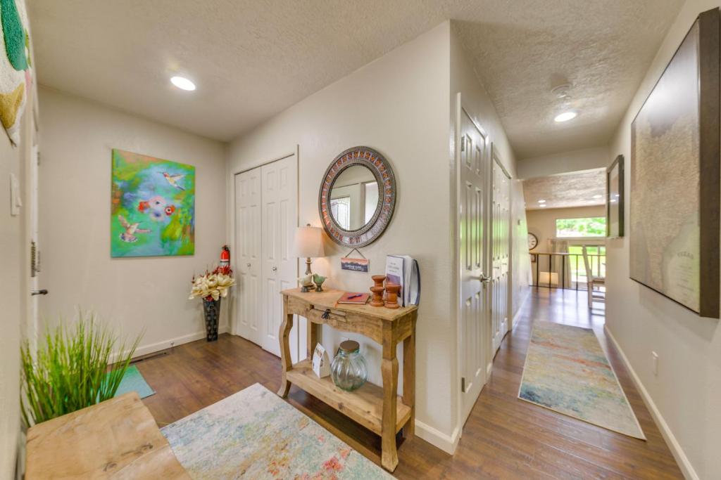 a hallway of a home with a table and a mirror at Ruidoso Golf Condo - Patio, Fire Pit and Mtn View! in Ruidoso