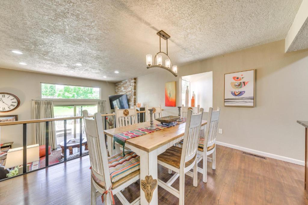 a dining room and kitchen with a table and chairs at Ruidoso Golf Condo - Patio, Fire Pit and Mtn View! in Ruidoso