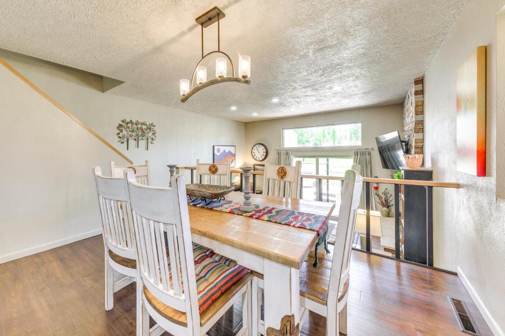 a dining room with a wooden table and chairs at Ruidoso Golf Condo - Patio, Fire Pit and Mtn View! in Ruidoso