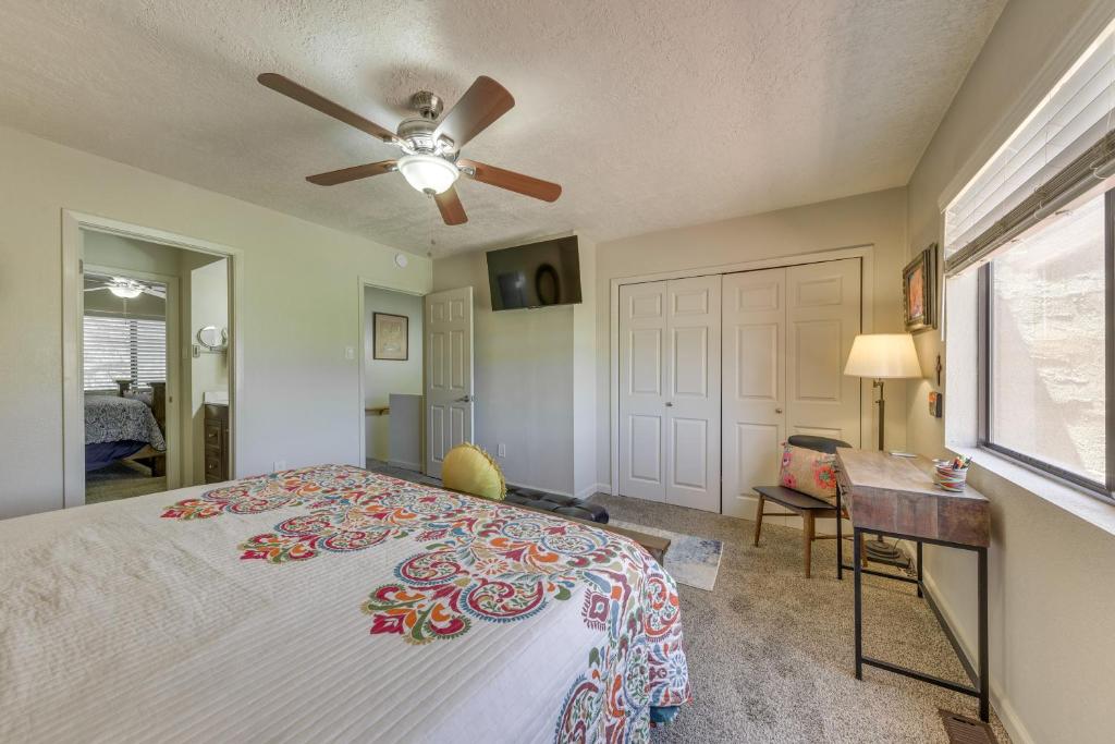 a bedroom with a bed and a ceiling fan at Ruidoso Golf Condo - Patio, Fire Pit and Mtn View! in Ruidoso