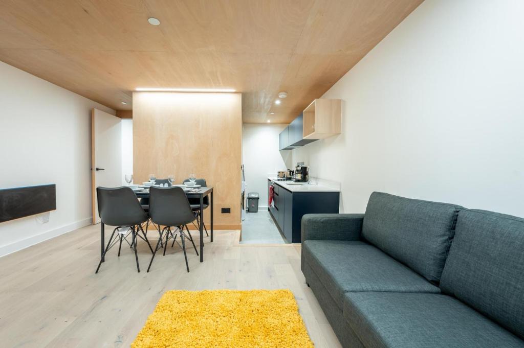 a living room with a couch and a table at Stunning 2BD Apartment in Manchester in Manchester