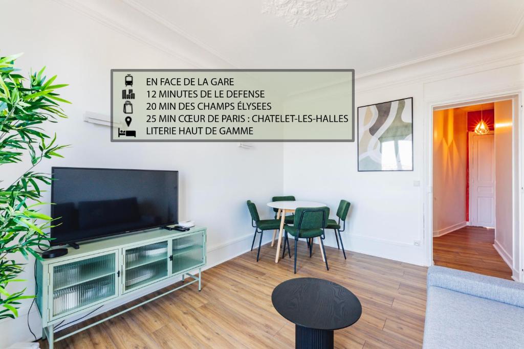 a living room with a tv and a table with chairs at Modern&Confort Fully Furnish Apartment ⭑ La Défense ⭑Champs Elysées⭑ RER A & L in Maisons-Laffitte