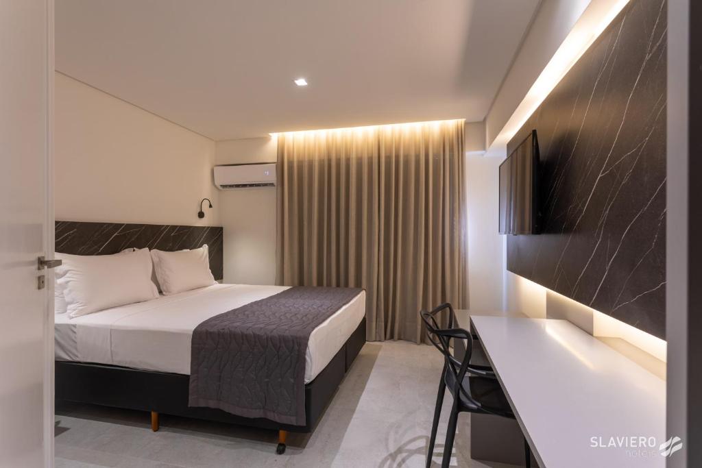 Cama ou camas em um quarto em Slaviero João Pessoa