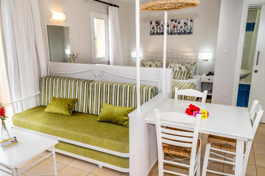 a living room with a couch and a table at Aktea Beach Village in Ayia Napa