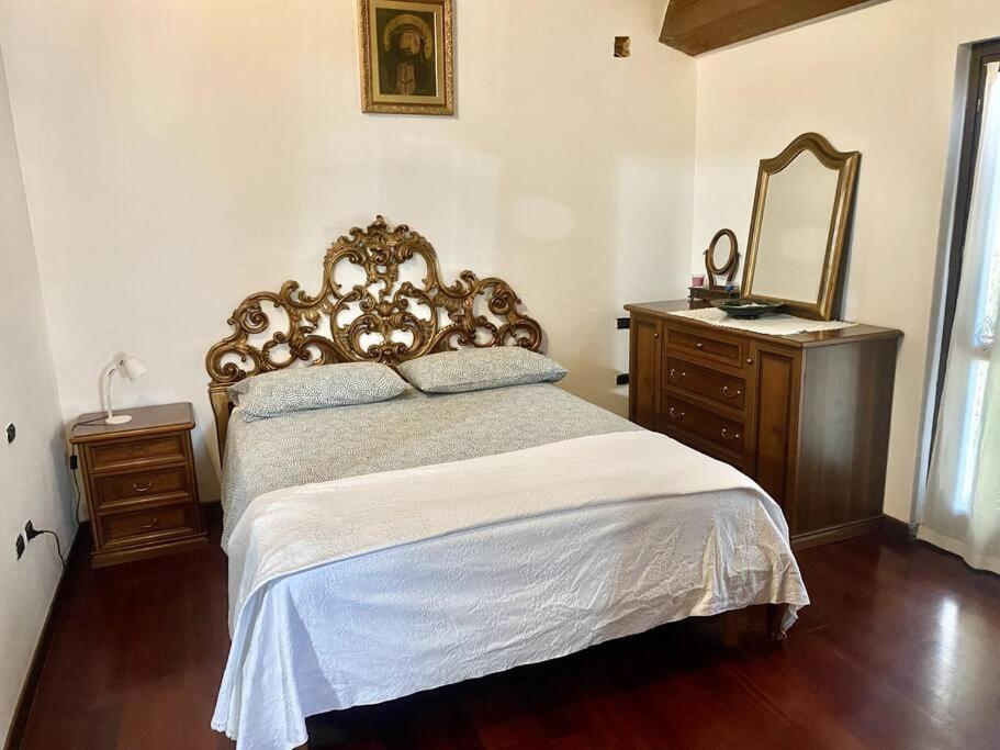 a bedroom with a large bed with a mirror and a dresser at Appartamento Santamarcellina in San Giorgio