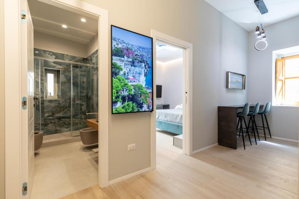a living room with a flat screen tv on a wall at Seven Winds Suite in Naples